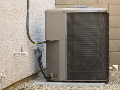 A gray outdoor air conditioning unit