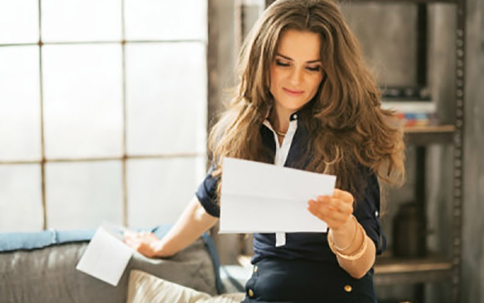 A woman reads a letter