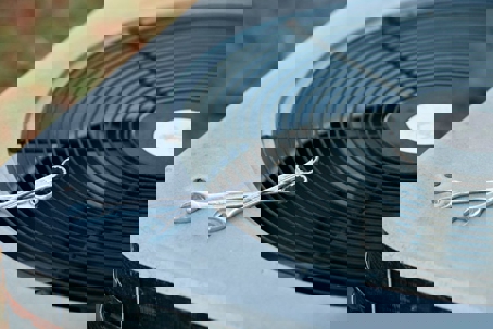 A well-lit close up shot depicts a residential air conditioning unit