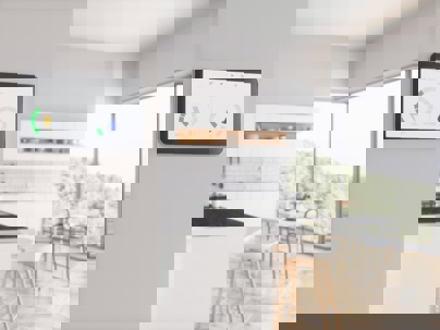 Smart home energy monitor on a wall in a modern kitchen