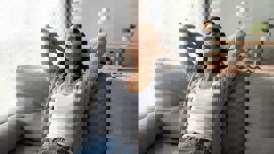 Woman relaxes on a sofa