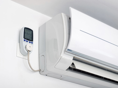 A white wall-mounted mini-split air conditioner with an energy meter