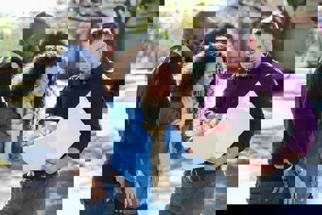 Three people looking at a document