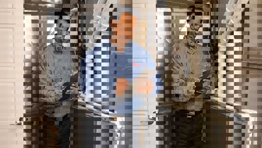 A technician inspects a home furnace