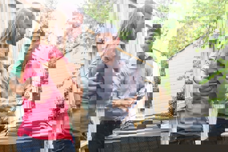 A couple is consulting with an HVAC technician