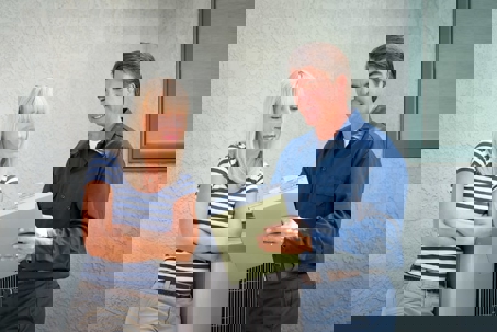 A woman consults with an HVAC technician